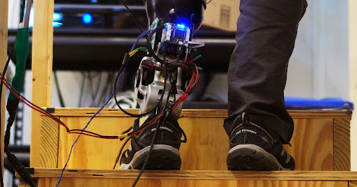 Motion capture equipment setup in the anatomical engineering lab showing biomechanical research apparatus attached to a participant's leg