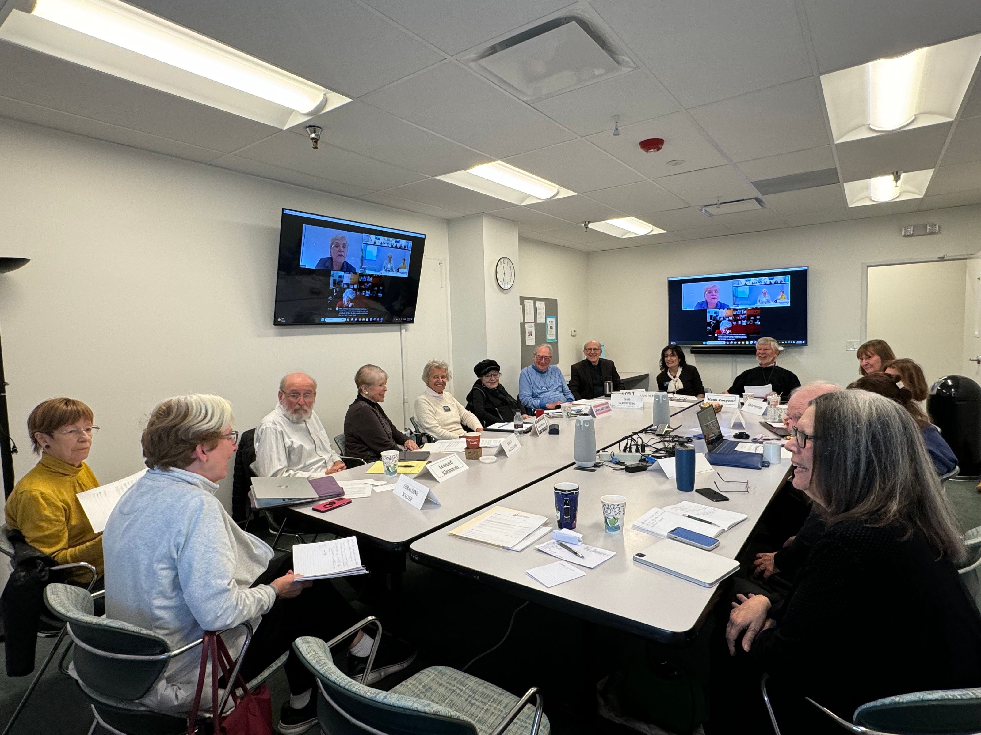 Plato Society discussion group meeting with elderly participants around a conference table