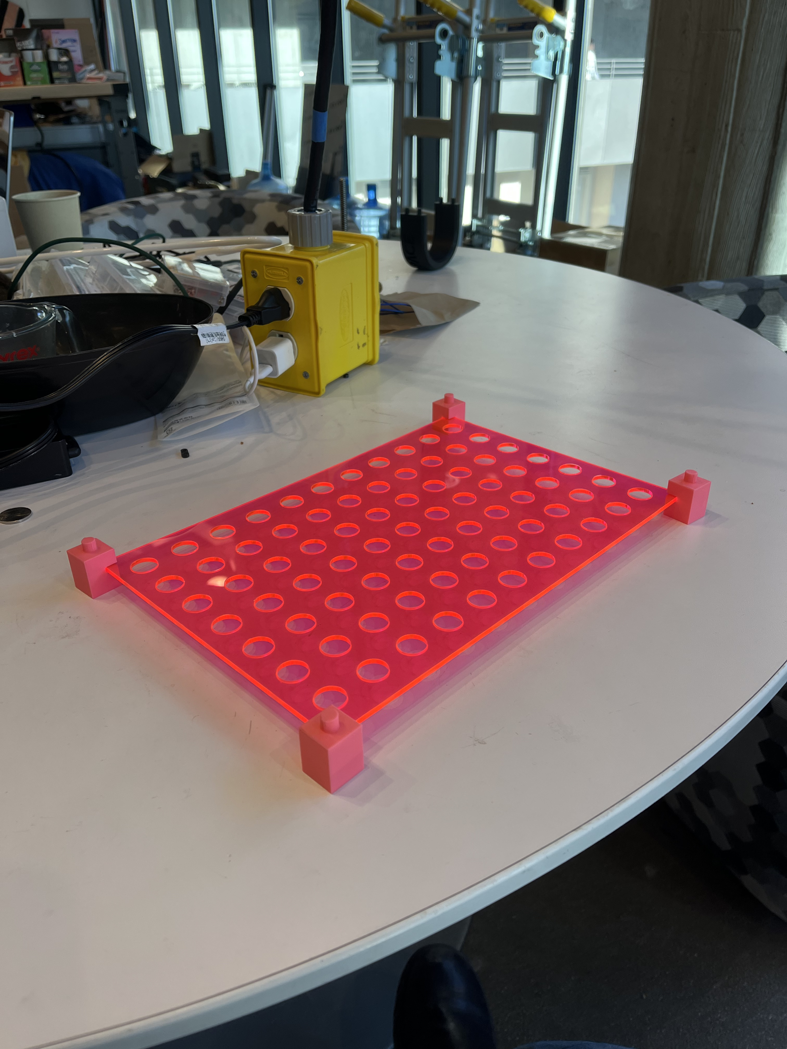 Red translucent 3D printed organizer tray with circular wells